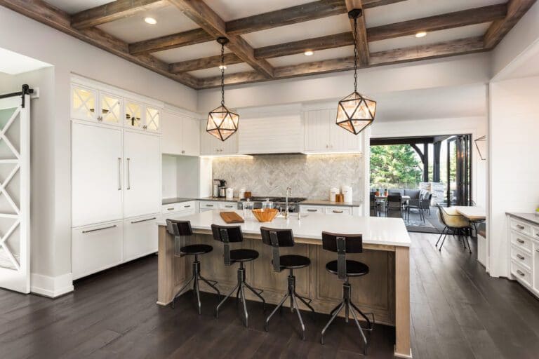 Modern kitchen with island and geometric pendant lights.