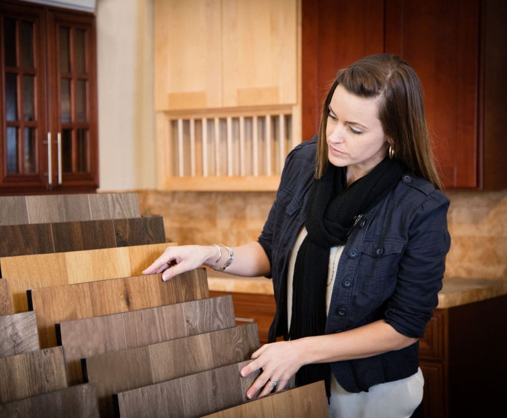 Woman inspecting wooden slats in a furniture store.