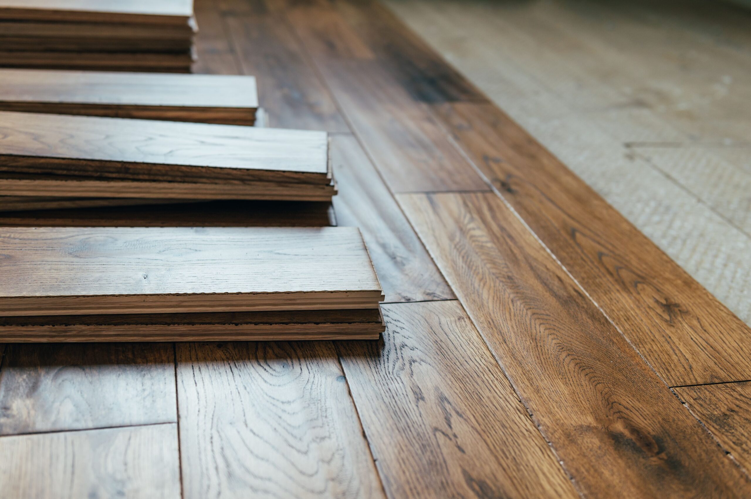 Wooden floor planks arranged on a finished wood floor.